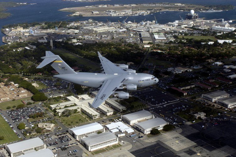 Image of an U.S. Airforce aircraft flying above Hickam Airforce Base on Oahu, Hawaii.