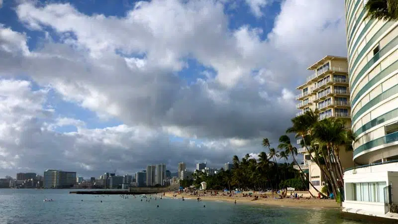 Wavy water on ocean off Kaimana Beach with hotels and condos