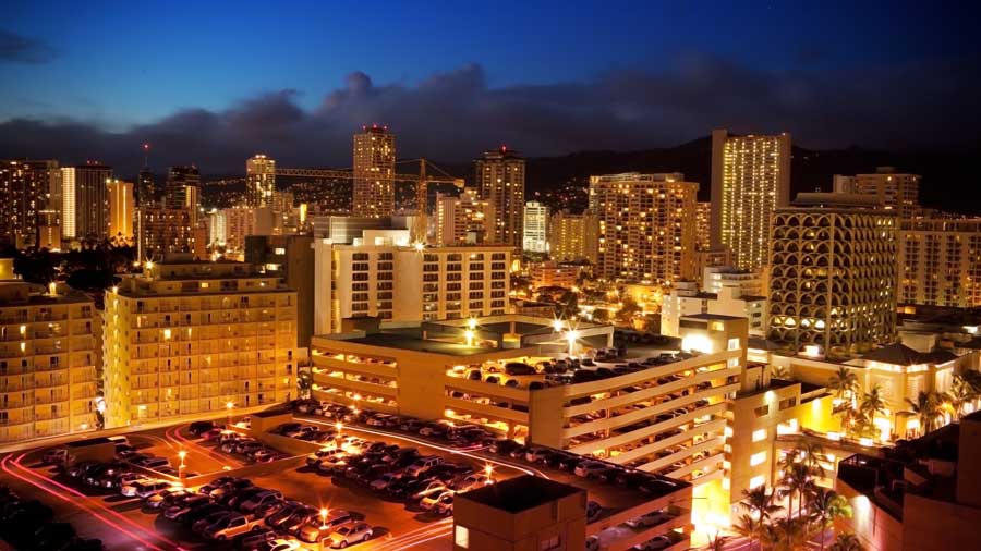 city view of Waikiki at night with lights and buildings