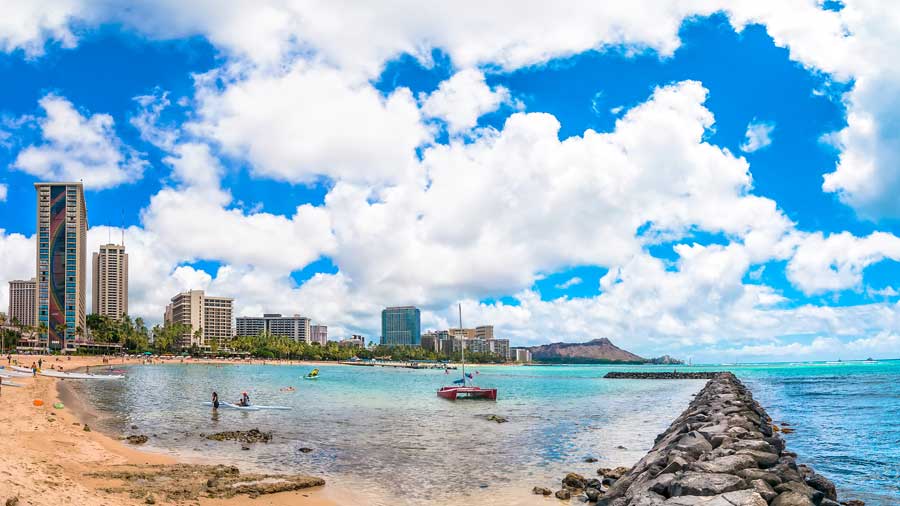 Waikiki shoreline with tourists in Honolulu Hawaii