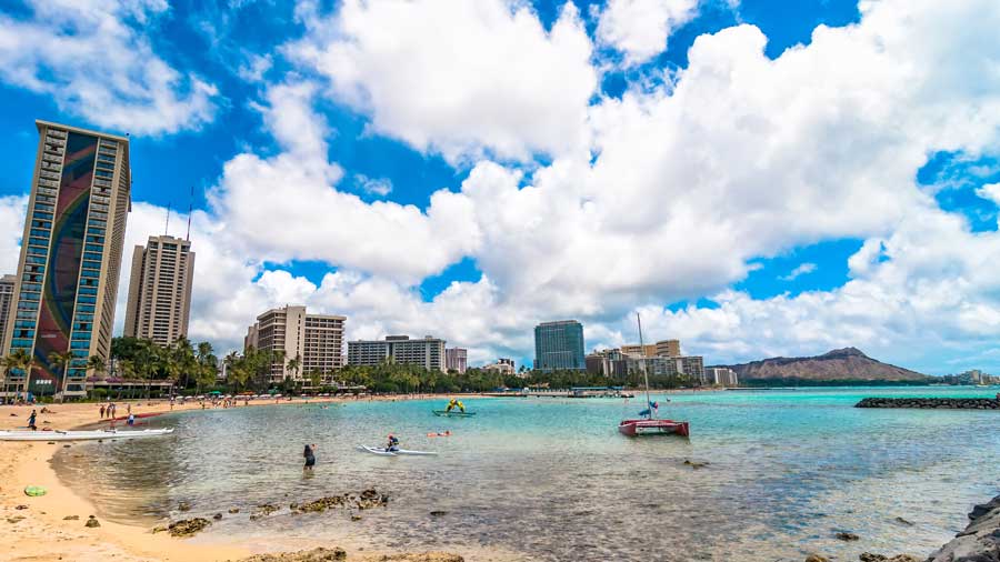 Waikiki shoreline with tourists in Honolulu Hawaii