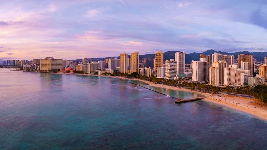 Waikiki beach and Honolulu skyline at sunset